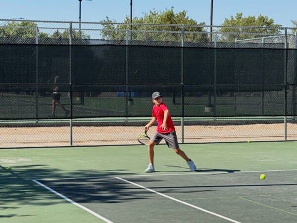 Junior player lining up a forehand on a Loveland hard court