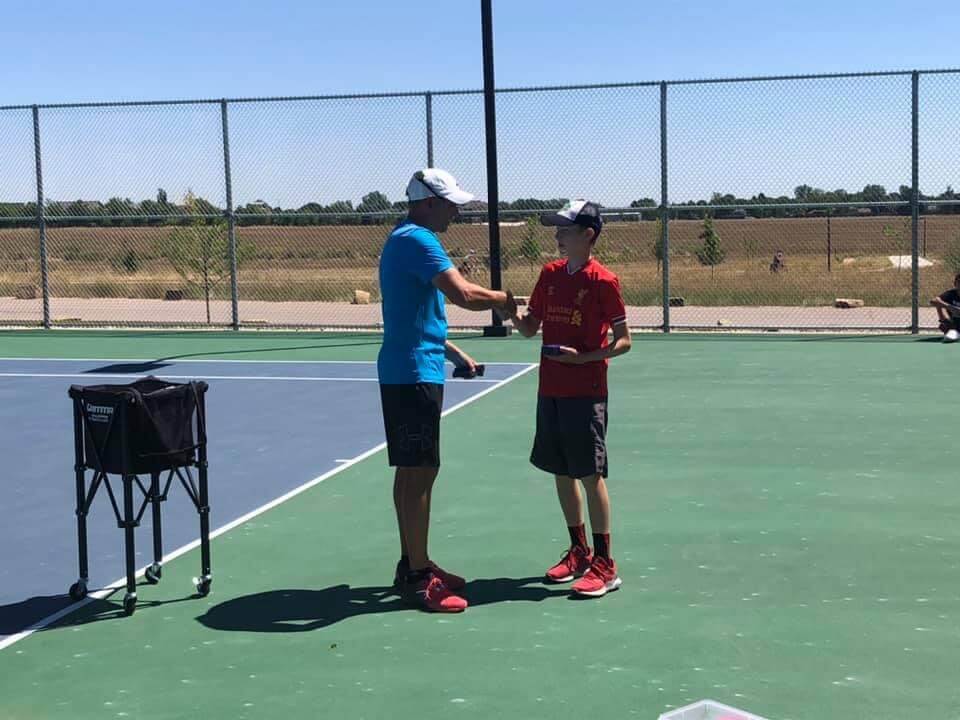 Coach and junior player during a practice session