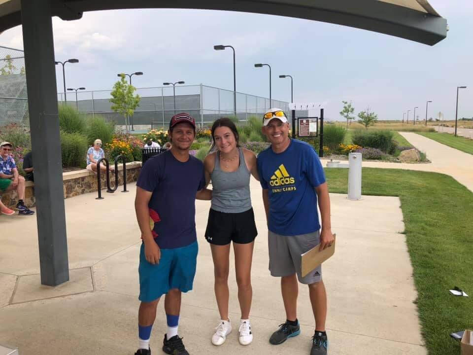 Front Range Academy coaches with a player at a tournament
